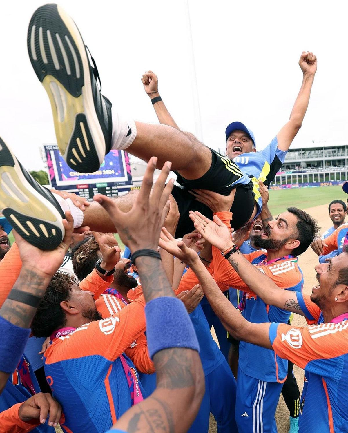 Head Coach Rahul Dravid is all smiles as the players hoist him 