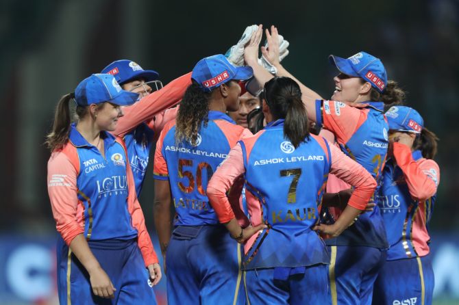 Mumbai Indians players celebrate the wicket of Hayley Matthews