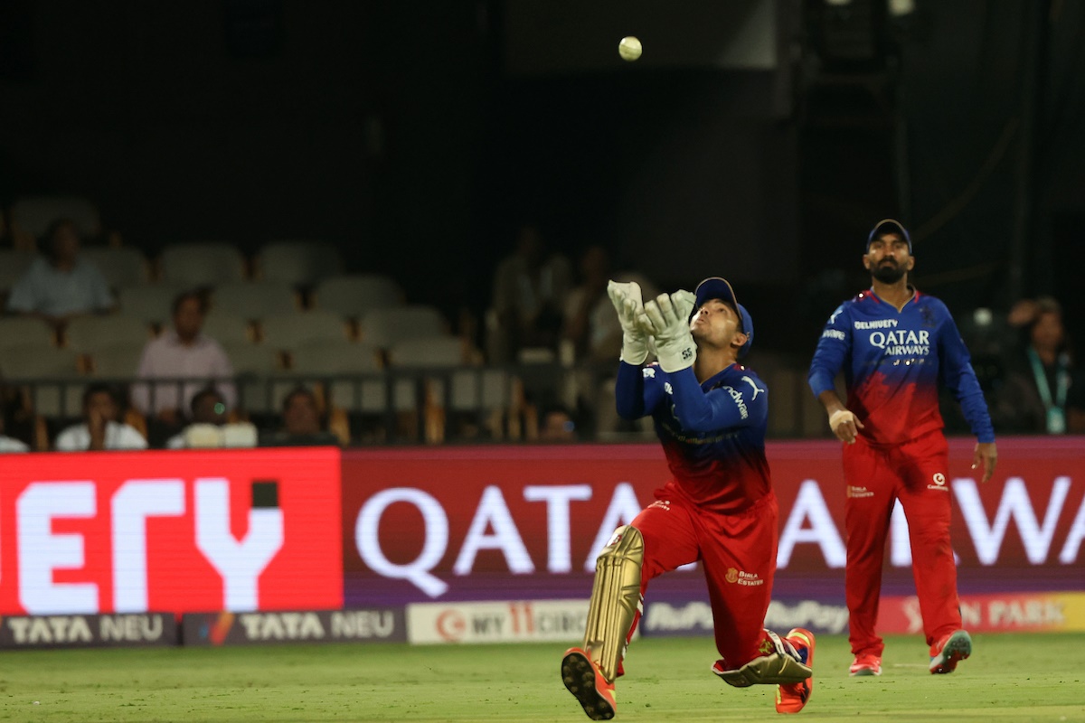 Anuj Rawat of Royal Challengers Bangalore takes the catch to dismiss Jitesh Sharma of Punjab King