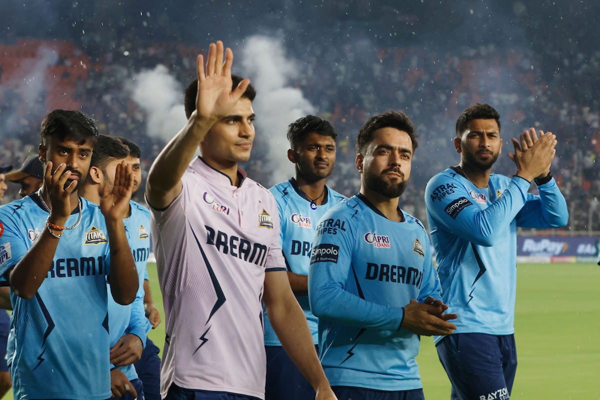 Gujarat Titans players take a lap of honour around the Ahmedabad Stadium after the match was called-off