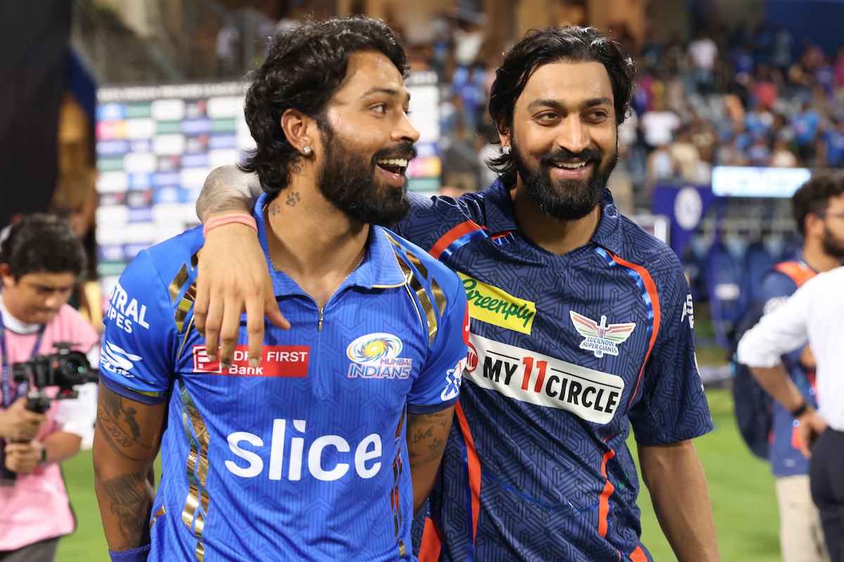 Mumbai Indians skipper Hardik Pandya and brother Krunal of Lucknow Super Giants share a light moment amidst the boos at the post-match presentation at the Wankhede stadium in Mumbai on Friday.