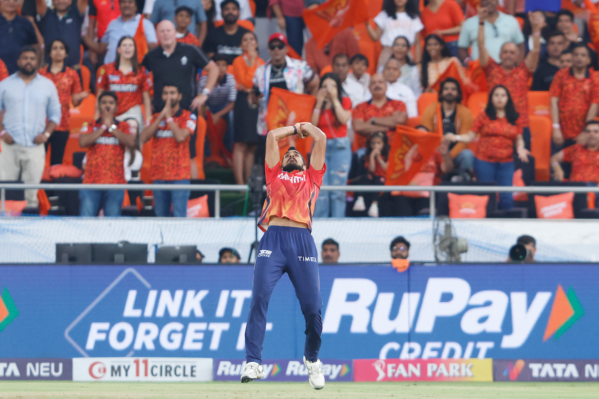 Arshdeep Singh takes the catch to dismiss Rahul Tripathi.