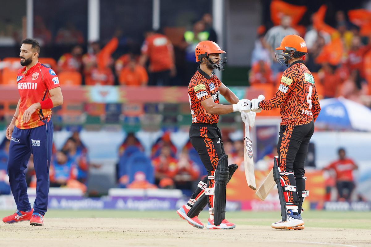 Rahul Tripathi and Abhishek Sharma celebrate their 50-run partnership.