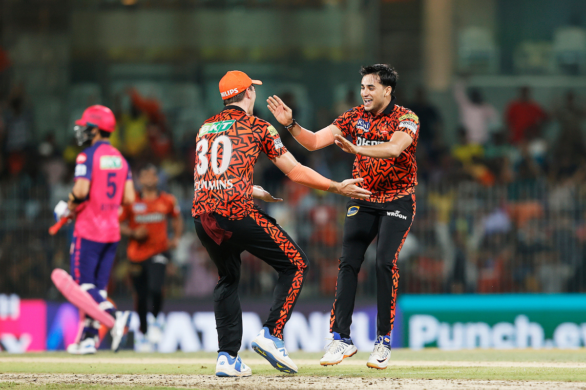 Sunrisers Hyderabad's Abhishek Sharma celebrates with captain Pat Cummins after dismissing Sanju Samson 