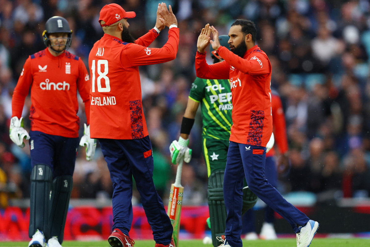 England's Adil Rashid celebrates with teammates after taking the wicket of Pakistan's Babar Azam