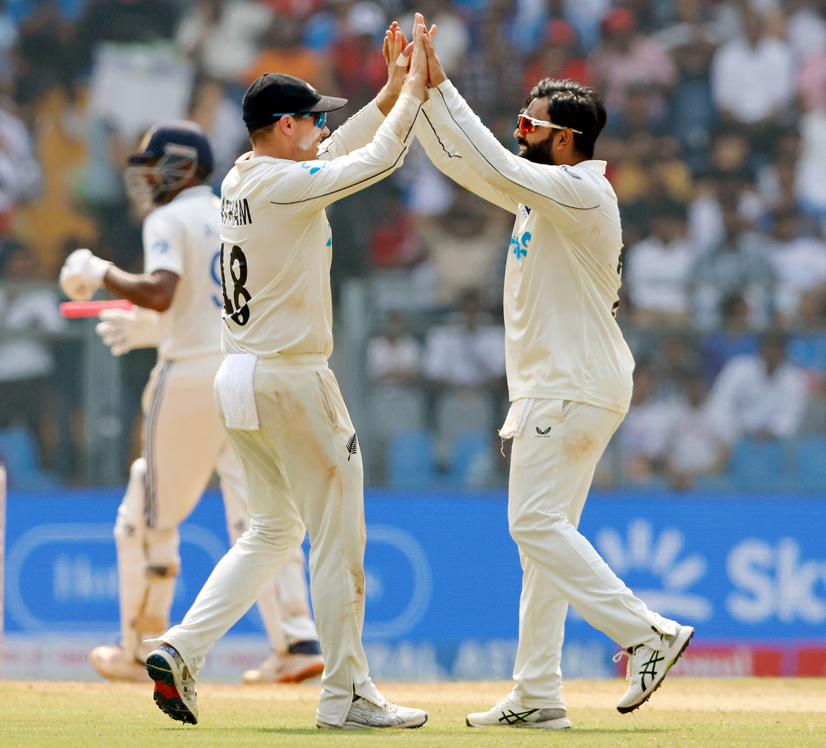 Ajaz Patel celebrates with teammates after taking the wicket of Ravichandran Ashwin.