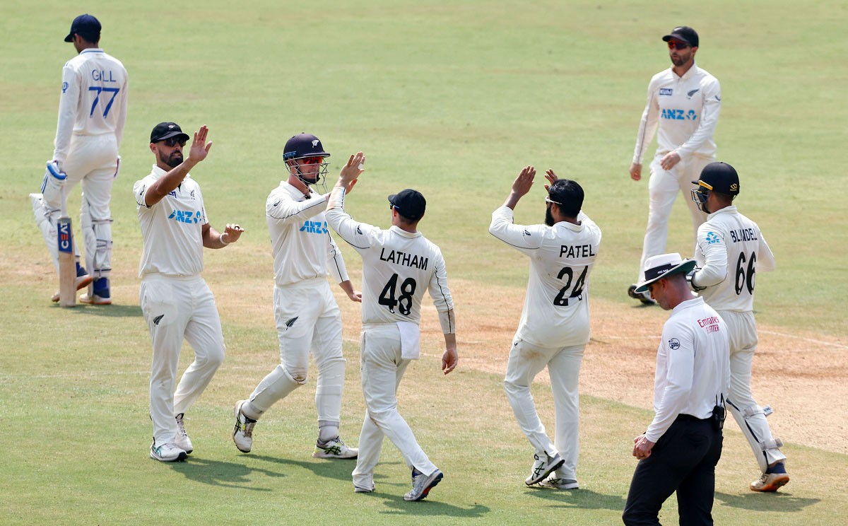 New Zealand's players celebrate the wicket of Shubman Gill, who was dismissed by Ajaz Khan.