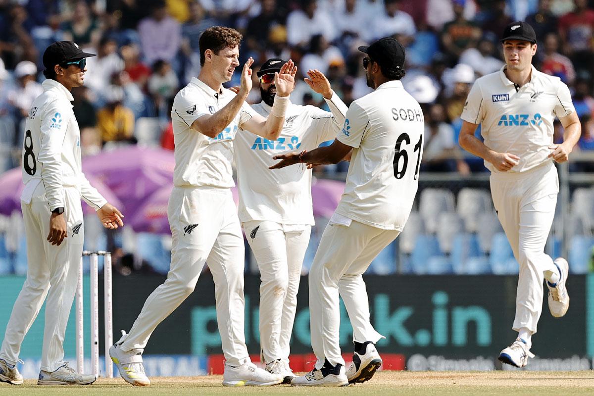 New Zealand's players celebrate the wicket of India captain Rohit Sharma