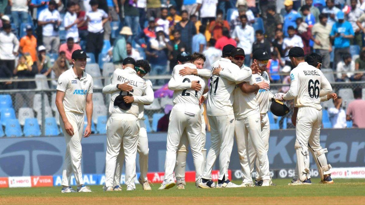 New Zealand's players celebrate after winning the third test match against India at Wankhede Stadium in Mumbai.