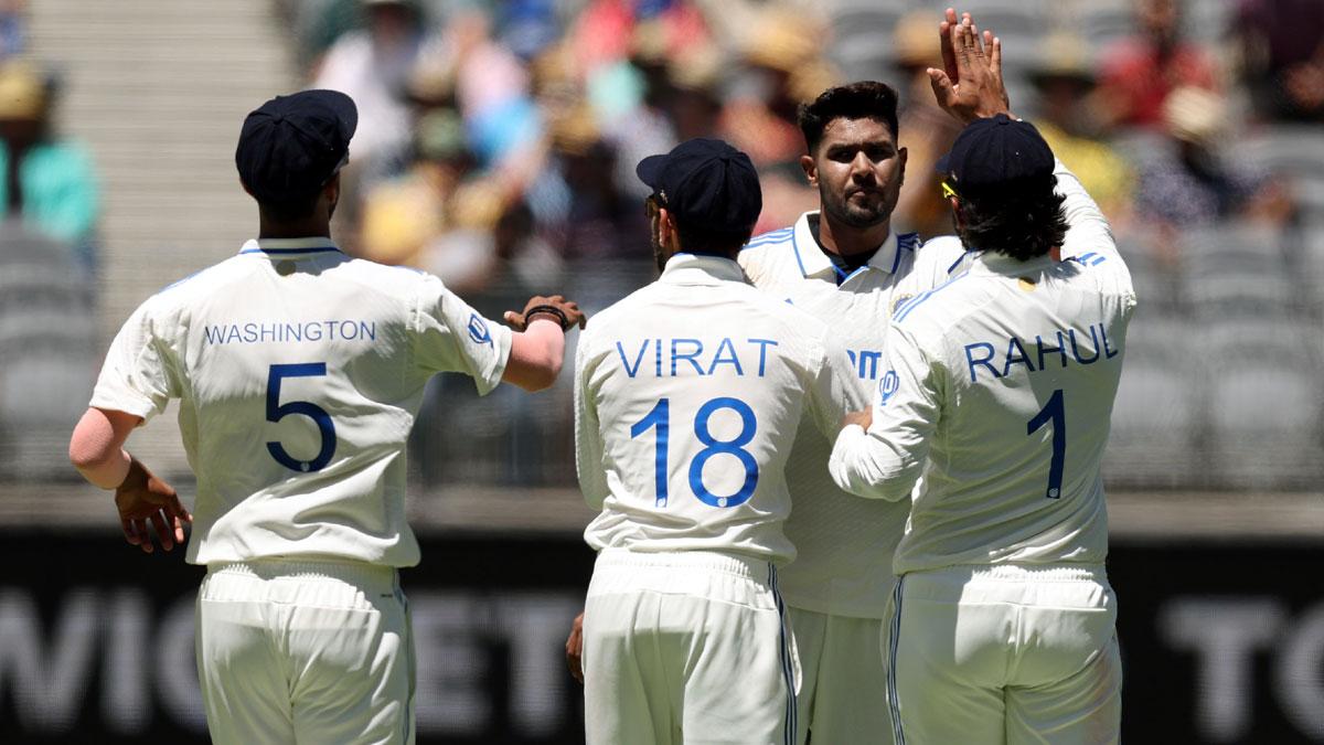 Harshita Rana celebrates with team-mates after taking the wicket of Mitchell Starc.