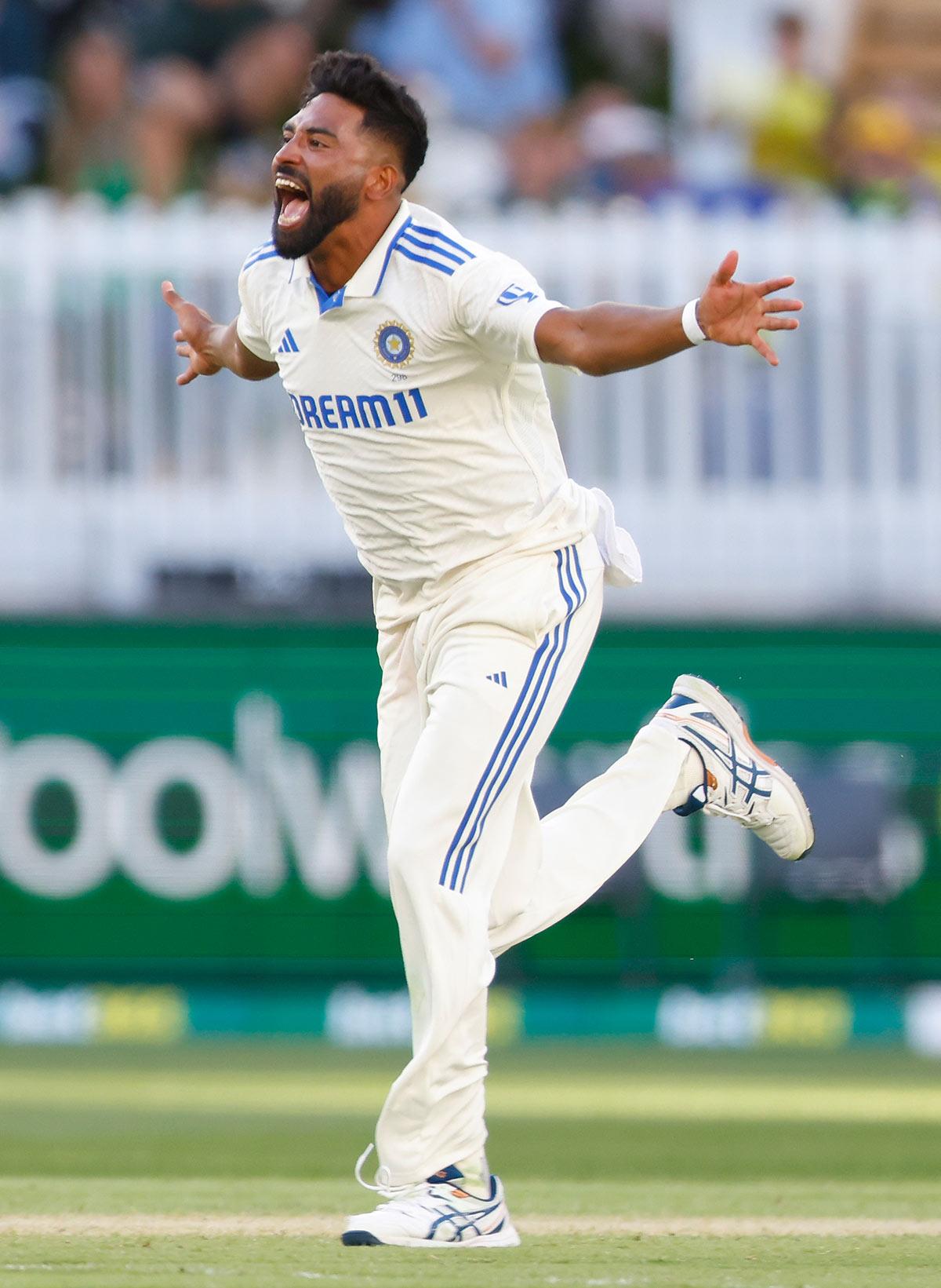 Mohammed Siraj celebrates after dismissing Pat Cummins