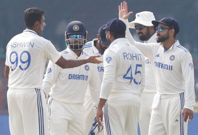 Ravichandran Ashwin celebrates with teammates after taking the wicket of Mominul Haque.