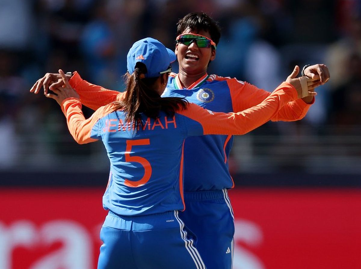 Deepti Sharma celebrates taking a wicket against Pakistan with a teammate.