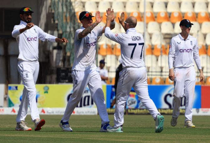 England's players celebrate winning the Multan Test