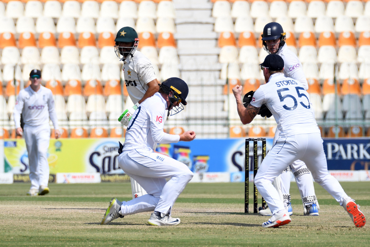 England's Ollie Pope celebrates after taking the catch to dismiss Pakistan's Shan Masood, off the bowling of Shoaib Bashir 