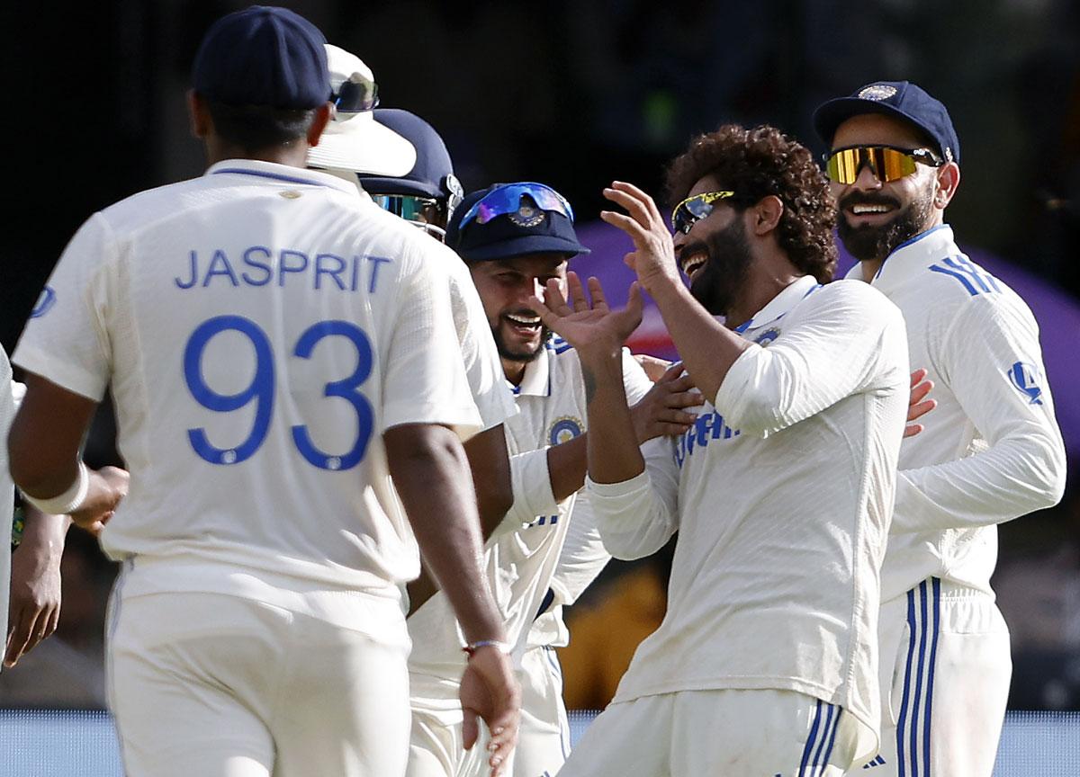 Ravindra Jadeja celebrates with teammates after taking the wicket of Will Young.