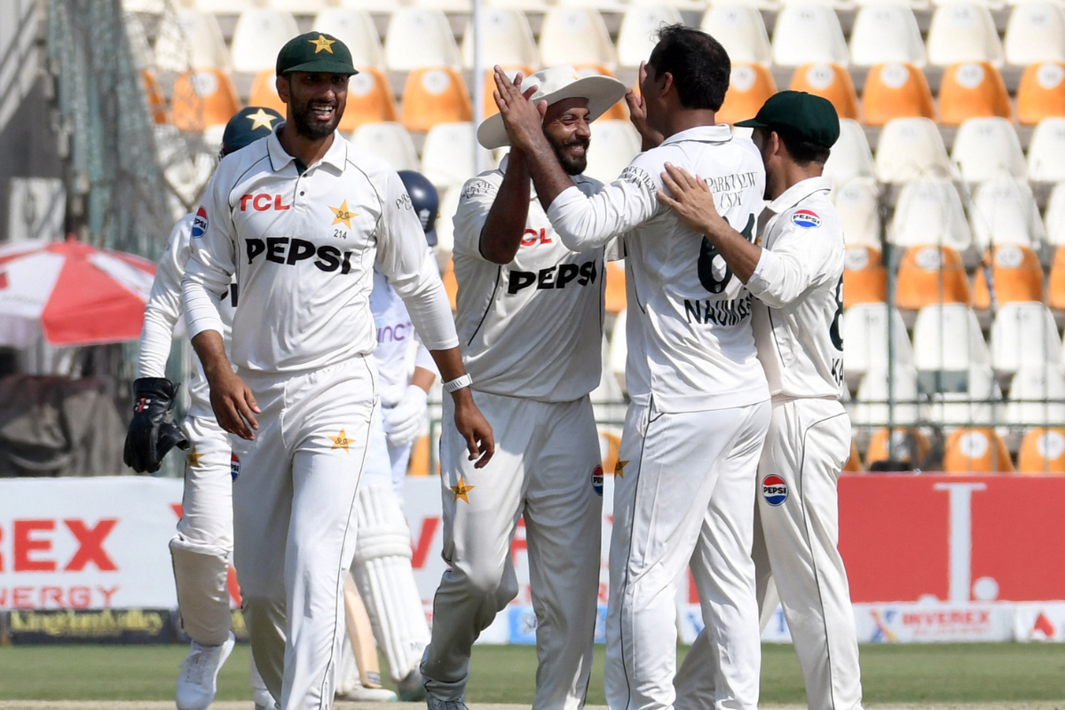 Pakistan's Noman Ali celebrates with teammates after taking the wicket of England's Jamie Smith, caught out by Saim Ayub