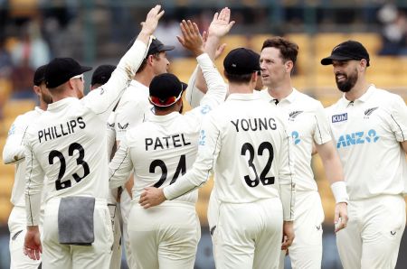 Matt Henry celebrates with teammates after taking the wicket of Ravindra Jadeja.