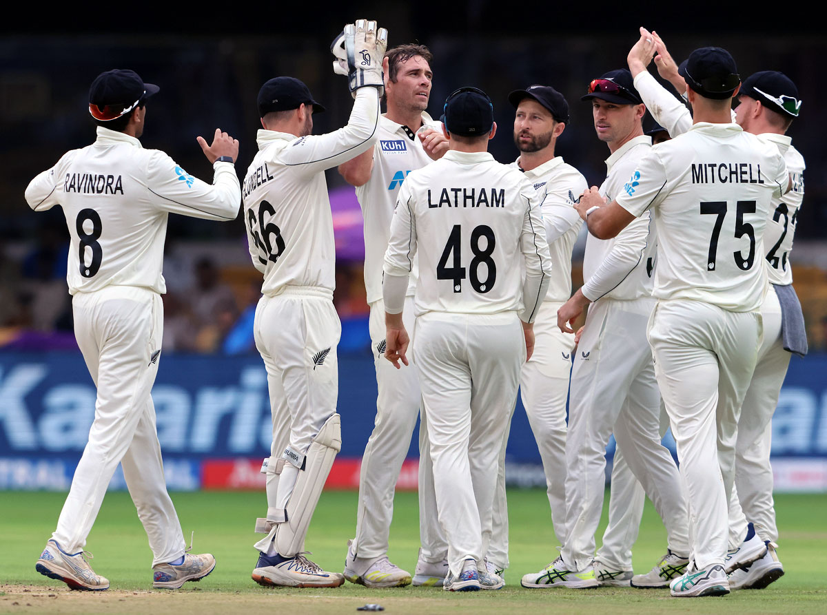 New Zealand's players celebrates after Tim Southee dismissed Rohit Sharma.