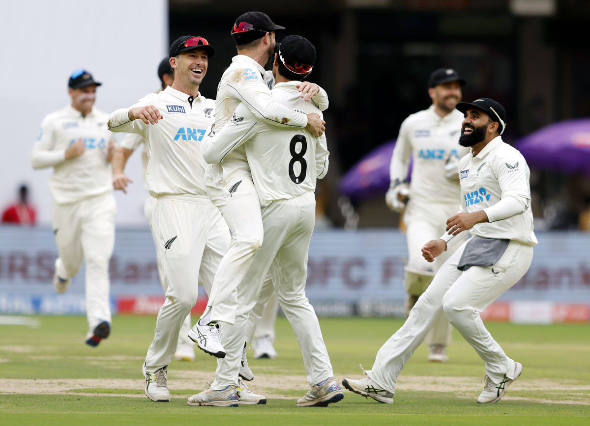 New Zealand's players celebrate the wicket of Sarfaraz Khan.