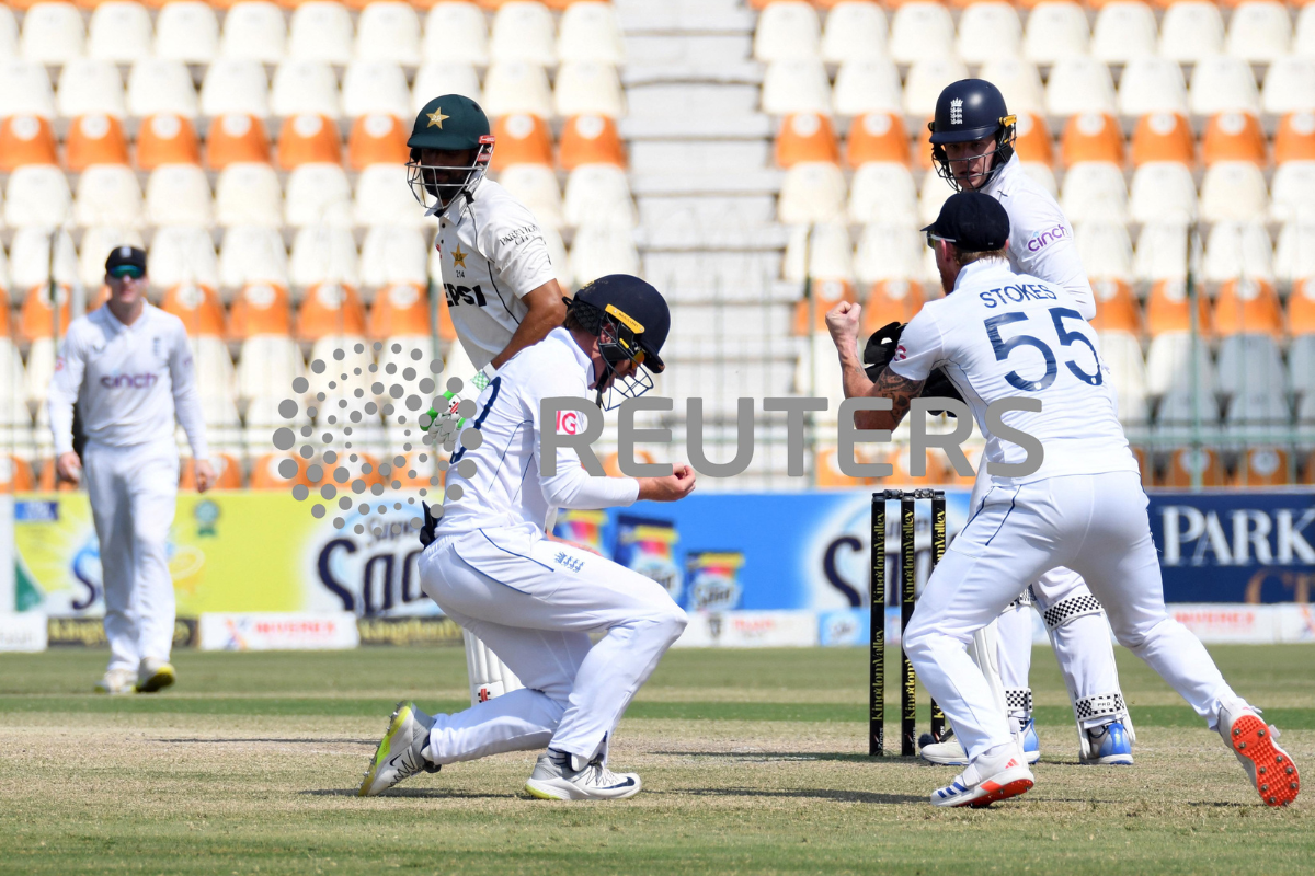 England's Ollie Pope celebrates after taking the catch to dismiss Pakistan's Shan Masood, off the bowling of Shoaib Bashir 