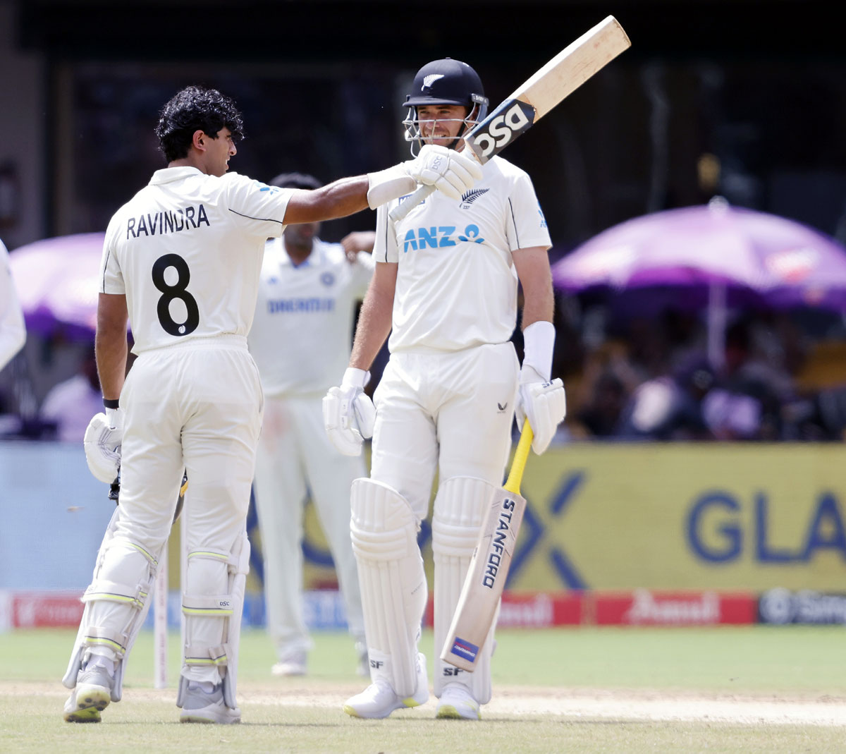 Rachin Ravindra celebrates after scoring a hundred.