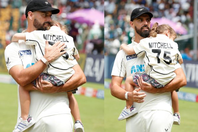 Daryl Mitchell with his daughter Lily after their win over India, in the opening Test in Bengaluru, on Sunday