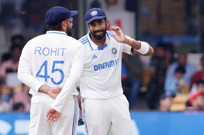 Indian captain Rohit Sharma discusses with vice captain Jasprit Bumrah on Day 5 of the 1st Test against New Zealand in Bengaluru, on Sunday