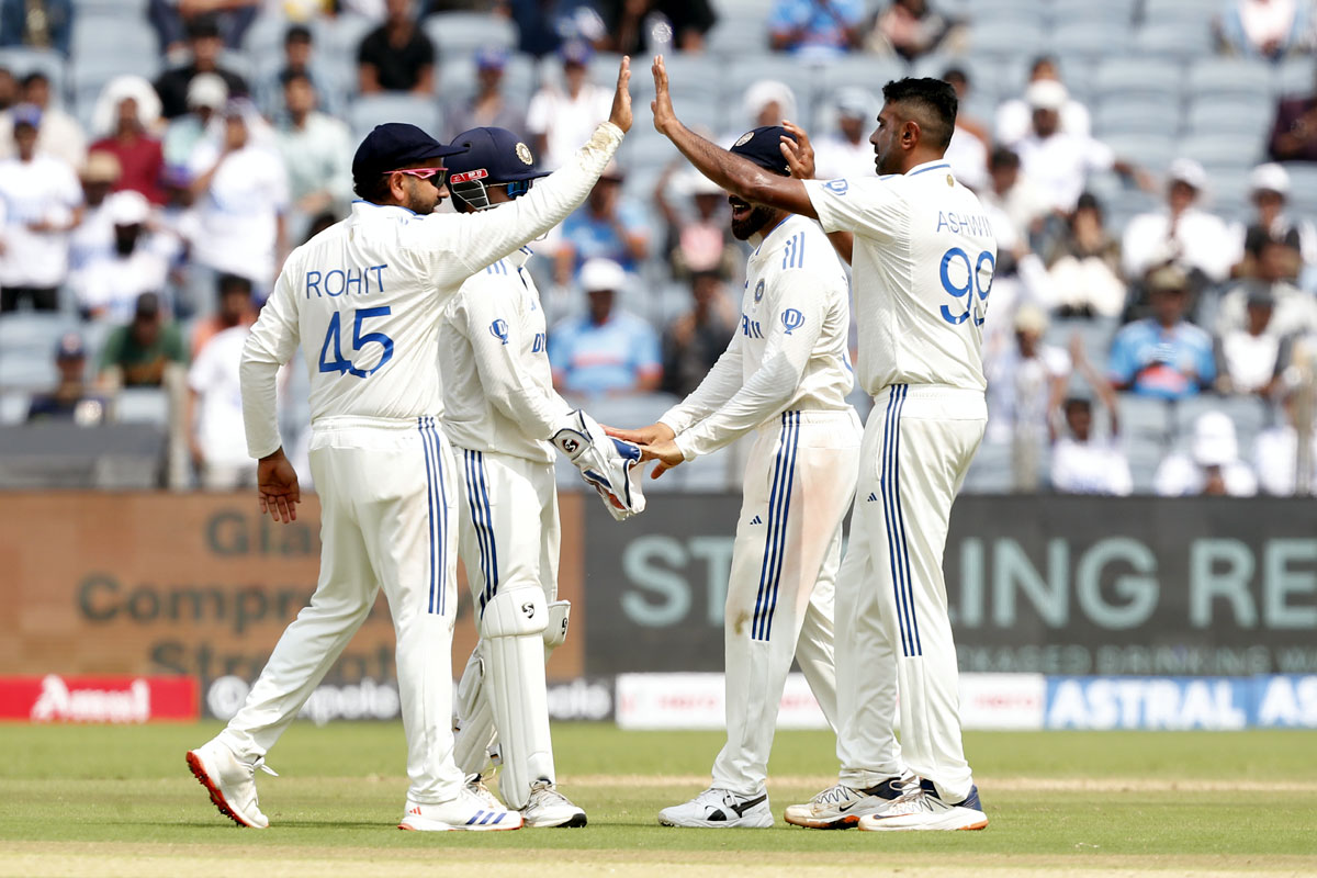 Ravichandran Ashwin celebrates with teammates after taking the wicket of Devon Conway.