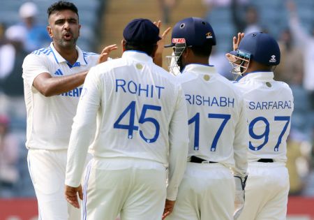 Ravichandran Ashwin celebrates with teammates after taking the wicket of Tom Latham.