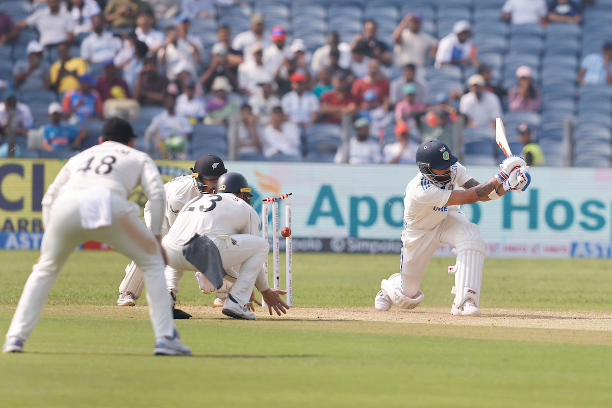 Virat Kohli gets clean bowled by Mitchell Santner during the first innings of the 2nd Test in Pune