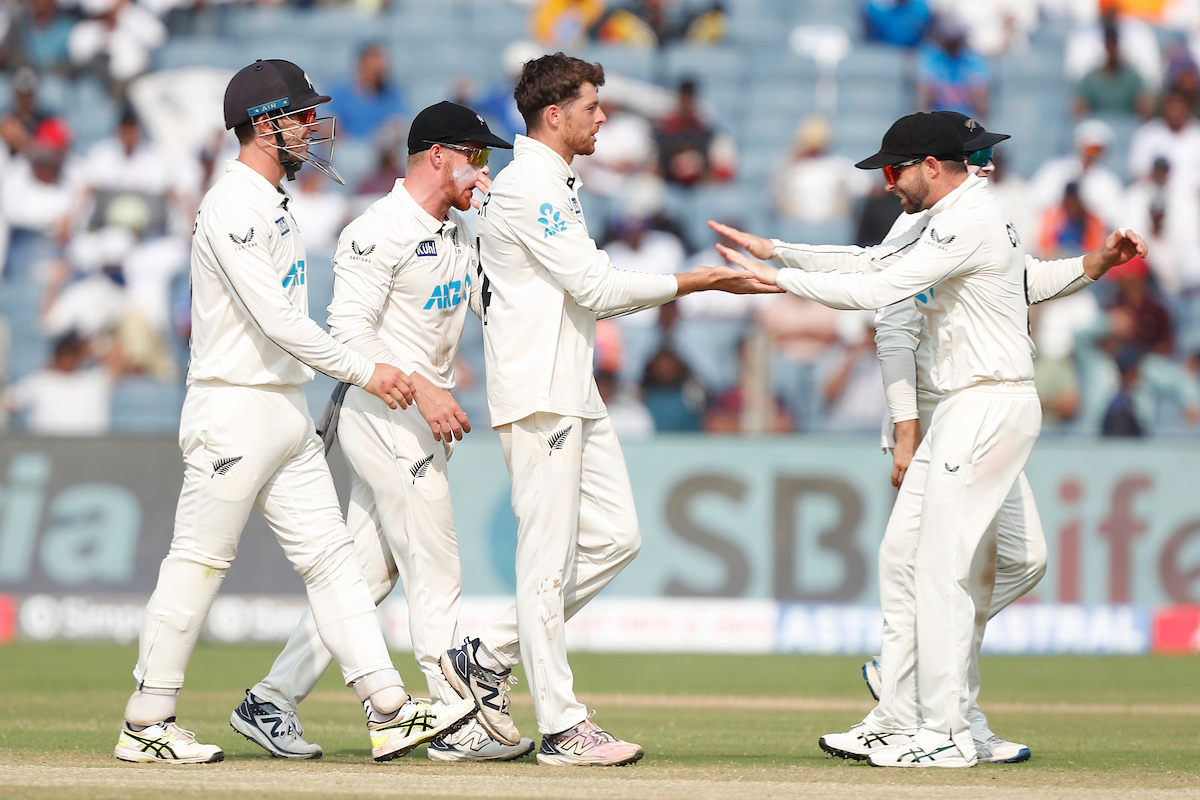 Mitchell Santner of New Zealand celebrates the wicket of Ravichandran Ashwin