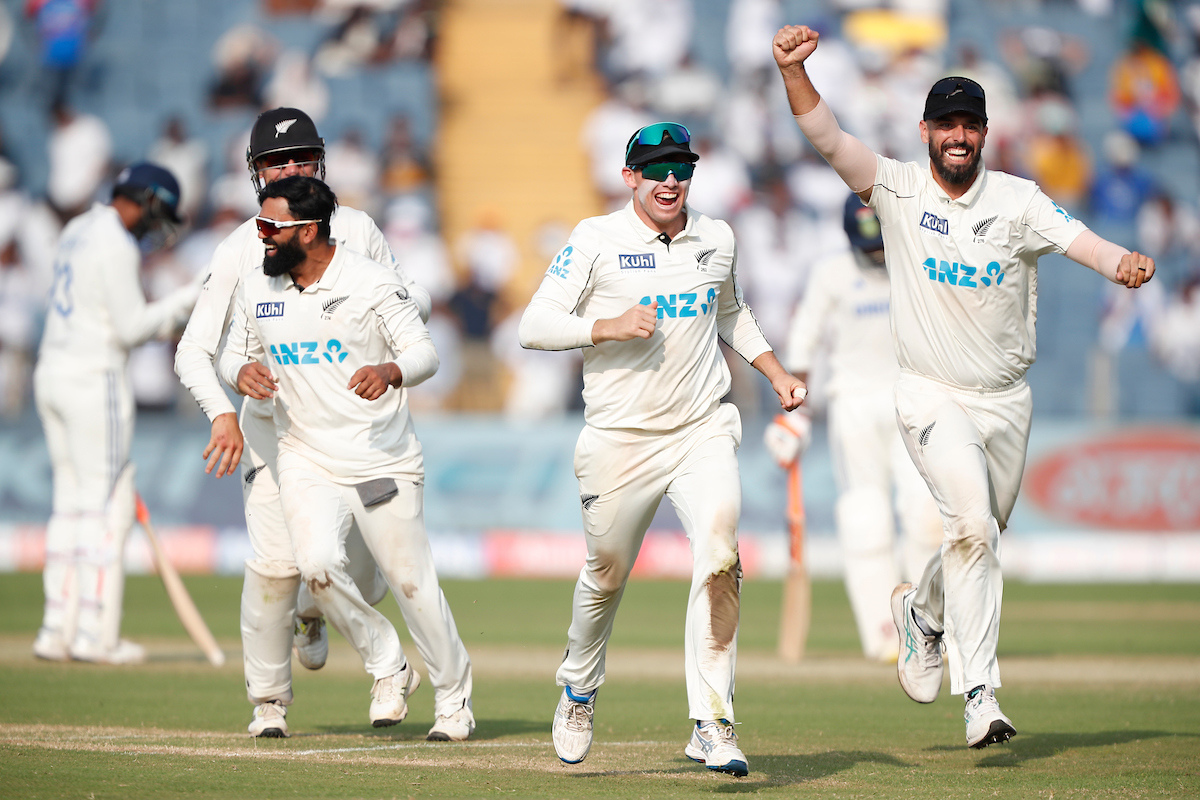 New Zealand players celebrate after their win over India in the 2nd Test in Pune on Saturday