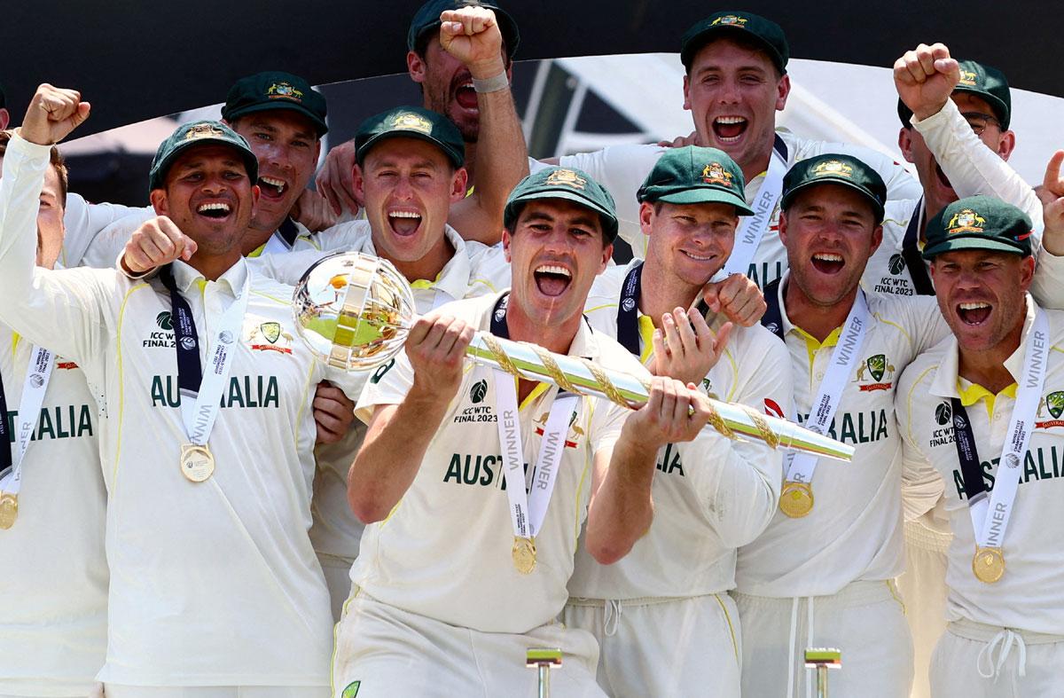 Australian players celebrate with the ICC Test Mace after defeating India to win the WTC final by 209 runs at The Oval in London on Sunday