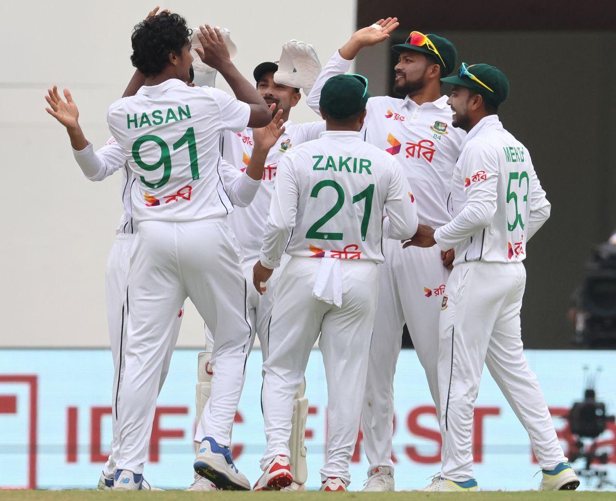 Bangladesh's players celebrate the wicket of India captain Rohit Sharma.