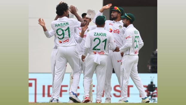 Bangladesh's players celebrate the wicket of India captain Rohit Sharma.