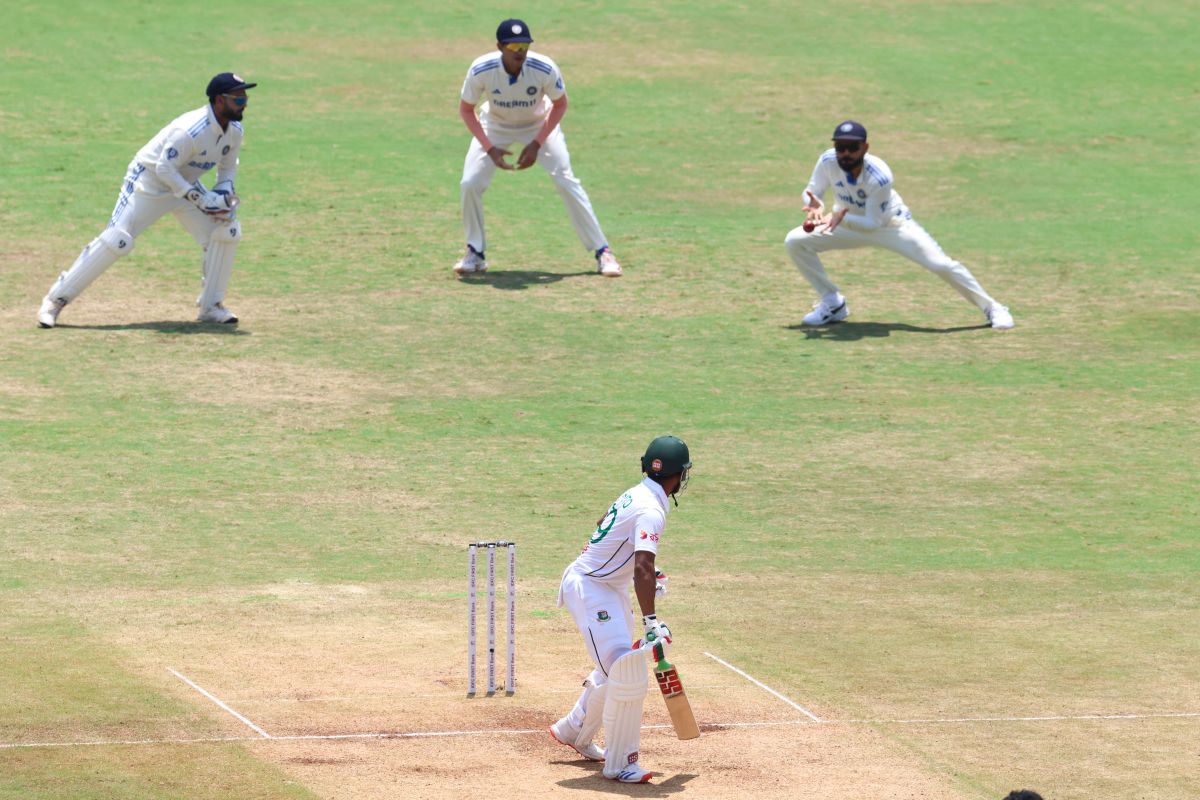 Virat Kohli takes the catch at second slip to dismiss Najmul Hossain Shanto off the bowling of Mohammed Siraj