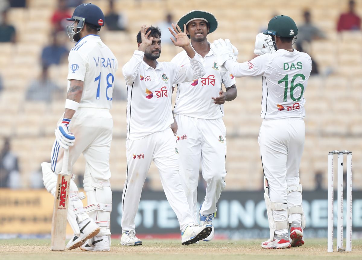 Bangladesh's players celebrate as Virat Kohli walks back