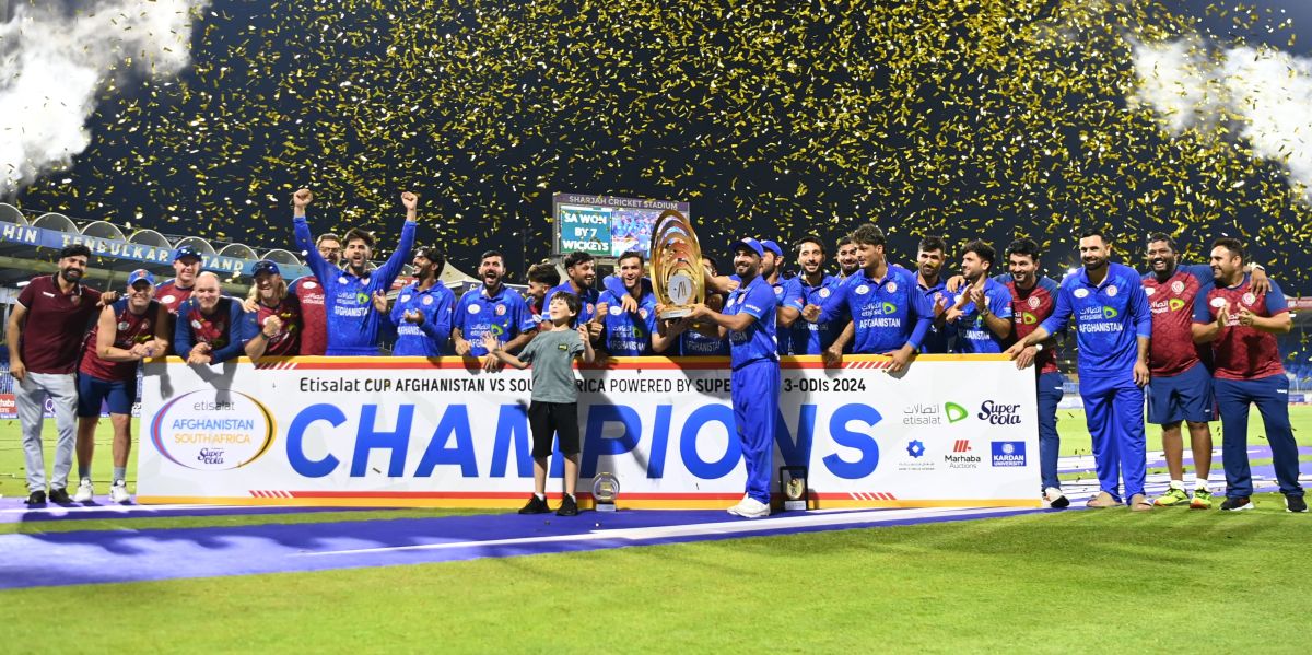 Afghanistan's players celebrate with the series trophy.