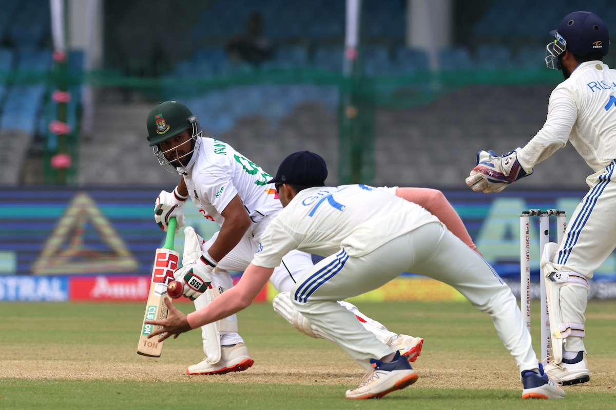 Bangladesh's Najmal Shanto watches on Shubman Gill goes on to completes a one-handed catch to end his stay at the crease