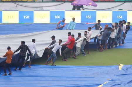 The groundstaff bring on the covers