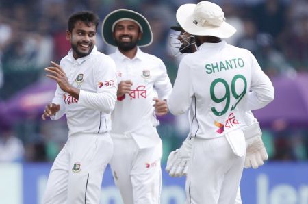 Mehidy Hasan Miraz celebrates with teammates after taking the wicket of Rohit Sharma.