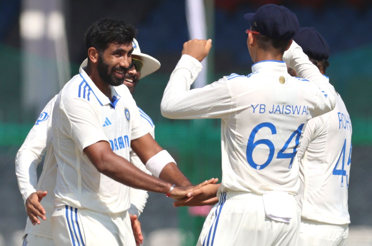 Jasprit Bumrah celebrates with teammates after taking the wicket of Mushfiqur Rahim.