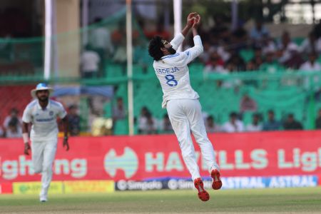 Ravindra Jadeja takes a catch off his bowling to dismiss Syed Khaled Ahmed, his 300th Test wicket