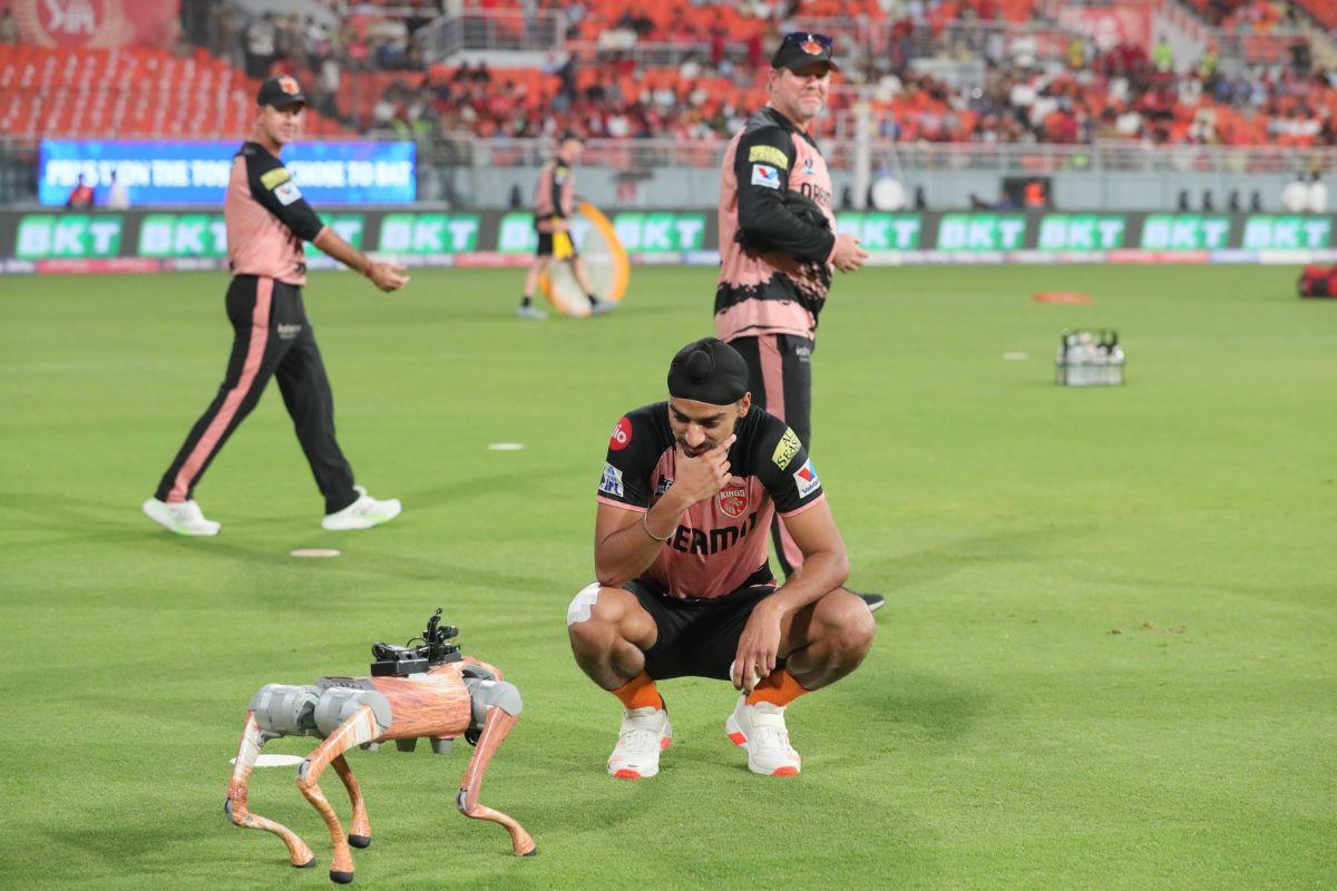 Arshdeep Singh looks in amazement at the Robot Dog ahead of their game against KKR on Tuesday