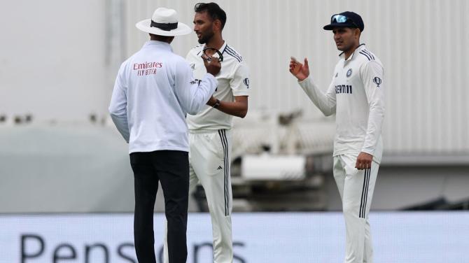 India's captain Shubman Gill watches as umpire Kumar Dharmasena steps in to calm things down after Prasidh Krishna and Joe Root exchange words during Day 2 of the fifth Test against England at Kia Oval, London, on Friday.