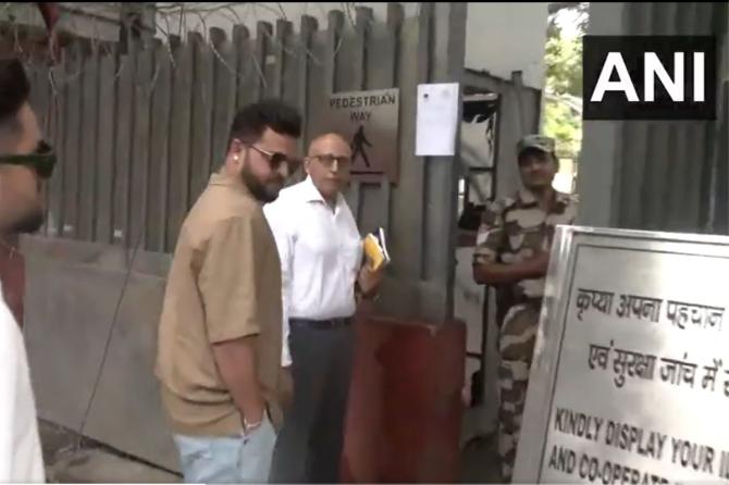 Former India cricketer Suresh Raina arrives at the Enforcement Directorate office in Delhi on Wednesday