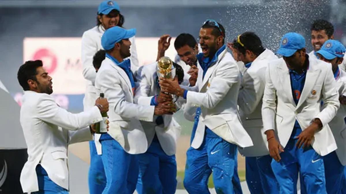 India's players celebrate with the trophy after beating England in the final of the 2013 ICC Champions Trophy at at Edgbaston, Birmingham, on June 24, 2013.