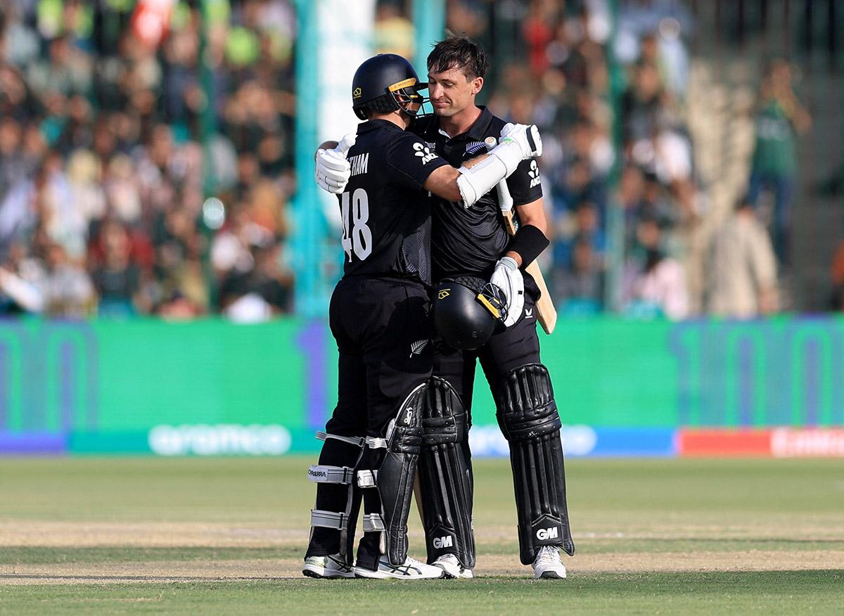 New Zealand's Will Young is congratulated by Tom Latham on reaching his century