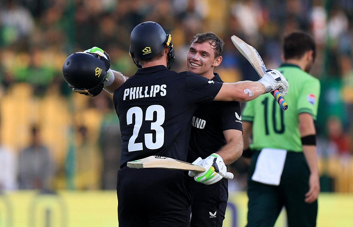 New Zealand's Tom Latham celebrates  with Glenn Phillips on reaching his century